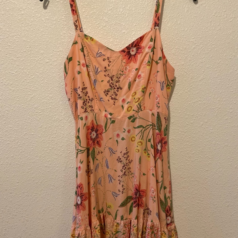 Coral-colored, knee-length floral sun dress